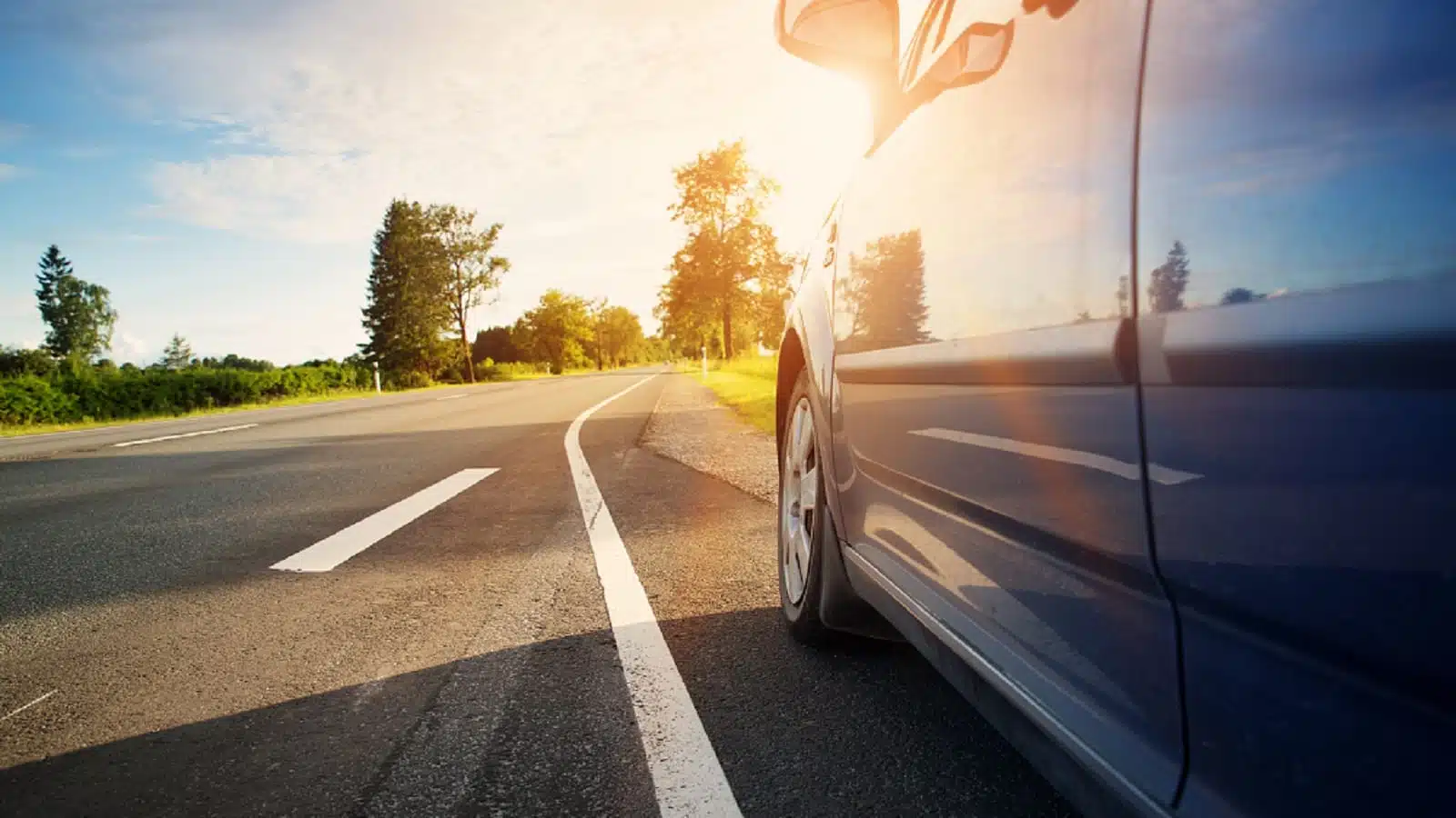 Car Parked On The Shoulder Of The Highway Stock Photo